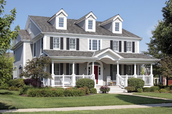A large gray shingle roof covers this home’s multiple gables, porch, and attached garage. Professional roof installation in Bristol NH can resolve persistent leaks and protect the structure from further moisture damage.