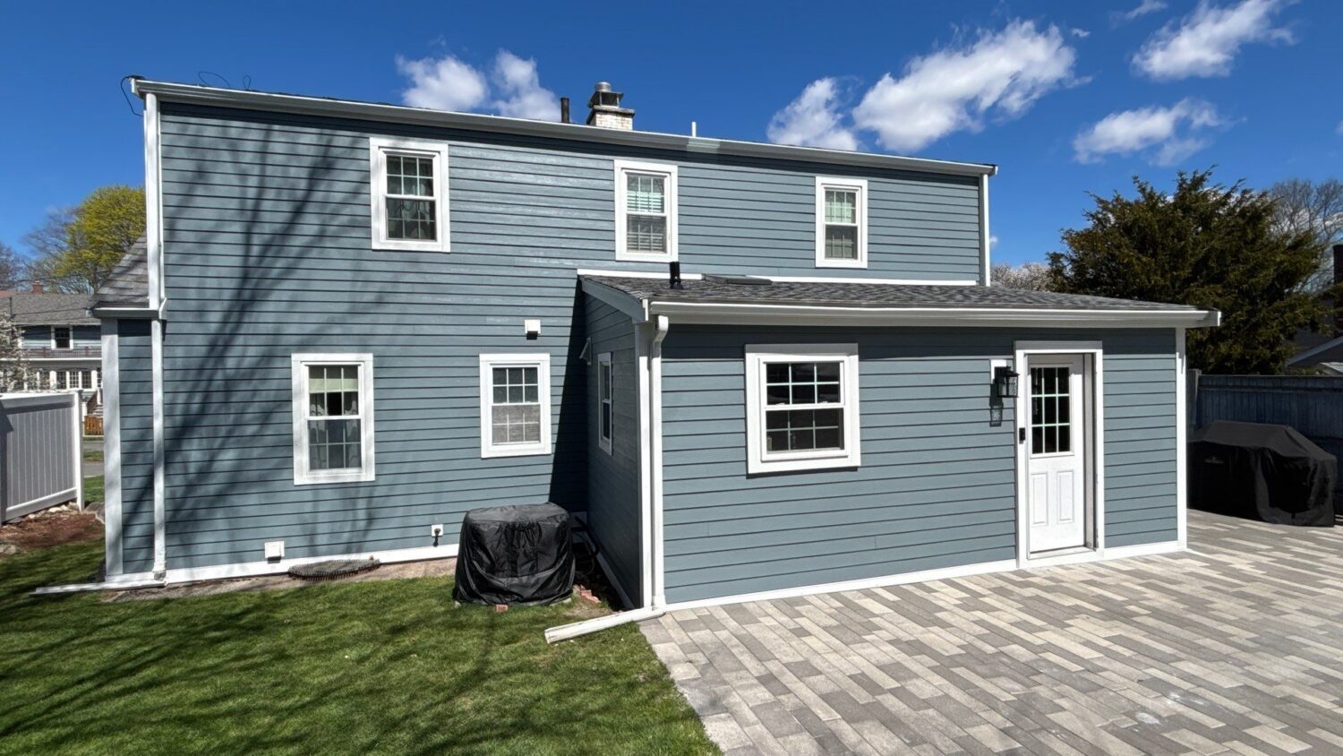 Light blue James Hardie fiber cement siding installed on a Massachusetts home, offering enhanced fire resistance and durability.