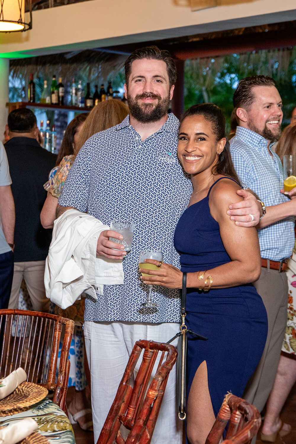 Two Coastal Windows & Exteriors team members pose together during a company celebration, marking a shared moment of recognition. Their work helps New Bedford, MA homeowners understand where water-damage repair fits into the average cost of siding a house.