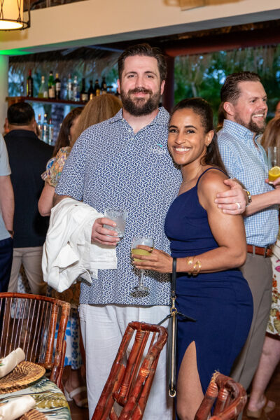 Two Coastal Windows & Exteriors team members pose together during a company celebration, marking a shared moment of recognition. Their work helps New Bedford, MA homeowners understand where water-damage repair fits into the average cost of siding a house.