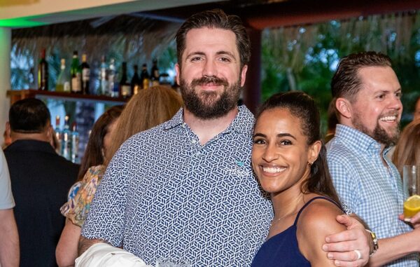 Two Coastal Windows & Exteriors team members pose together during a company celebration, sharing a moment of recognition. Their work helps Portsmouth, NH homeowners replace water-damaged siding with durable Hardie fiber cement.