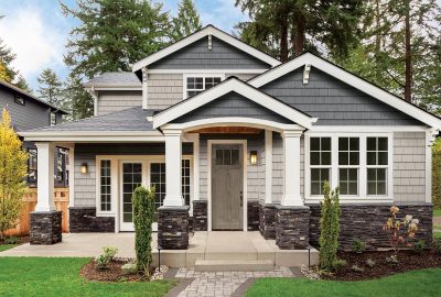 A modern gray house with white trim and vinyl siding in Bedford MA